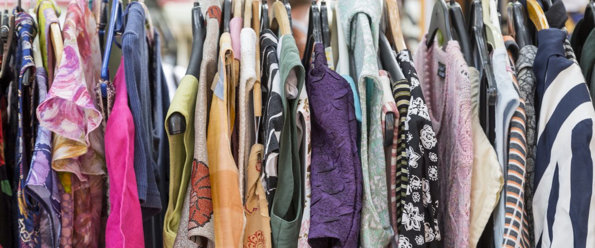 clothes on a rack on a flea market.